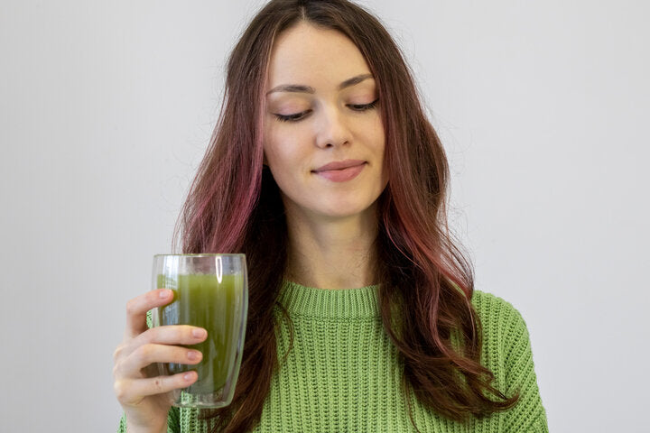 The morning, the drink and the concept of people. A young woman with a cup of martya tea. Beautiful girl about to drink a detox drink to lose weight