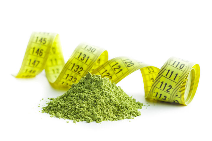 Green matcha tea powder with a measuring tape around it
