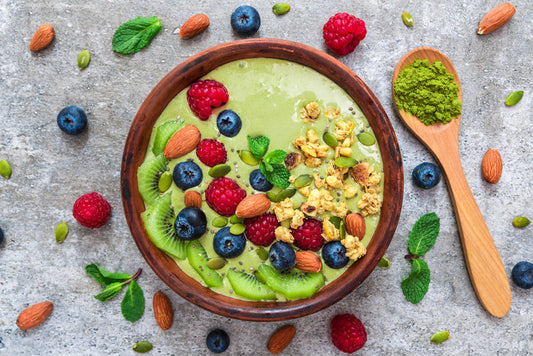 Smoothie bowl with berries, kiwi, almonds, seeds, granola