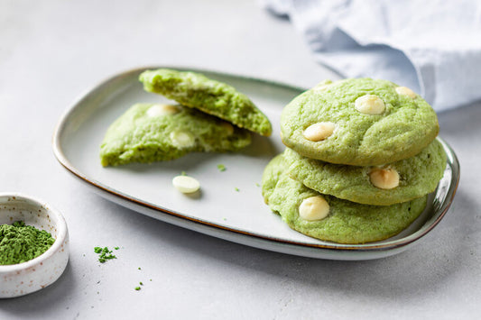 Green cookies with white chocolate chips on plate