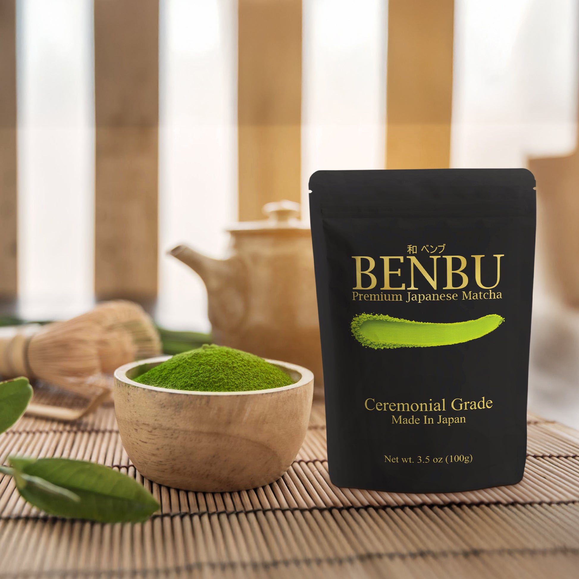 BENBU Matcha 100 g bag with bowl of matcha powder and tea tools on wooden surface