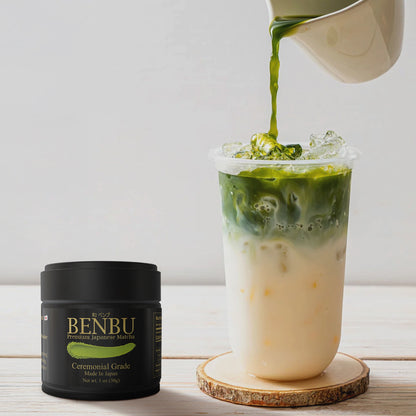 BENBU Ceremonial Grade Matcha 30g Tin next to iced matcha latte being poured – premium Japanese matcha