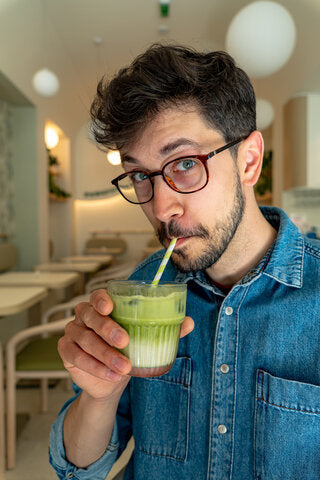 Man drinking benbu matcha green smoothie in a casual setting